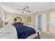 A bright bedroom with a ceiling fan, dresser, walk-in closet, and neutral carpet at 4558 Baleno Ln, Kissimmee, FL 34746