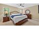 Relaxing bedroom with a ceiling fan, two windows, and wood furniture at 4558 Baleno Ln, Kissimmee, FL 34746