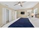 Spacious bedroom featuring a ceiling fan, closet, mounted television, and ensuite bathroom at 4558 Baleno Ln, Kissimmee, FL 34746