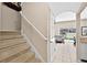 Hallway view with carpeted stairs leading to the second level and backyard pool access at 4558 Baleno Ln, Kissimmee, FL 34746