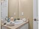 Bathroom vanity with sink, faucet, mirror, towels and toiletries at 4558 Baleno Ln, Kissimmee, FL 34746