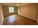 Neutral bedroom with wood-look flooring and a large window, offering natural light at 4792 Summerfield Cir, Winter Haven, FL 33881