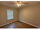 Bedroom with neutral walls, wood-look flooring and large window at 4792 Summerfield Cir, Winter Haven, FL 33881
