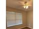 Bedroom with neutral walls, wood-look flooring and large window at 4792 Summerfield Cir, Winter Haven, FL 33881