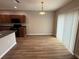 Open dining area with wood-look floors, modern lighting, and adjacent to kitchen at 4792 Summerfield Cir, Winter Haven, FL 33881