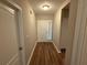 Inviting entryway with wood-look floors, a white front door, and a coat closet at 4792 Summerfield Cir, Winter Haven, FL 33881