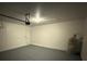 View of the spacious garage with epoxy flooring and a water heater in the corner at 4792 Summerfield Cir, Winter Haven, FL 33881