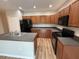 Functional kitchen featuring an island, wood cabinets, and sleek black appliances at 4792 Summerfield Cir, Winter Haven, FL 33881
