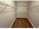 Walk-in closet featuring shelving, wood-look flooring and ample storage space at 4792 Summerfield Cir, Winter Haven, FL 33881
