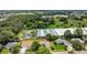 Scenic aerial view showcasing a house surrounded by lush greenery and nearby greenhouses in a serene setting at 4836 Pierce Arrow Dr, Apopka, FL 32712