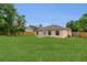 Well-maintained backyard with lush green grass and a wooden fence, providing privacy and a pleasant outdoor space at 4836 Pierce Arrow Dr, Apopka, FL 32712