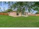 Lush green backyard with a privacy fence, offering a serene and private outdoor space for relaxation and recreation at 4836 Pierce Arrow Dr, Apopka, FL 32712