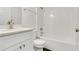 This bathroom features a tiled shower over tub combination, white cabinets and modern fixtures at 4836 Pierce Arrow Dr, Apopka, FL 32712
