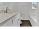 Renovated bathroom featuring modern vanity with white cabinets, brushed gold fixtures and tub at 4836 Pierce Arrow Dr, Apopka, FL 32712