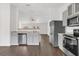 Modern kitchen with gray cabinets, stainless steel appliances, and a breakfast bar at 4836 Pierce Arrow Dr, Apopka, FL 32712