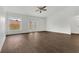 Bright and airy living room features wood-look floors, backyard access, and a ceiling fan at 4836 Pierce Arrow Dr, Apopka, FL 32712