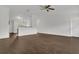 Open-concept living room with wood-look floors and stylish breakfast bar overlooking kitchen at 4836 Pierce Arrow Dr, Apopka, FL 32712