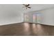 Spacious living room features modern ceiling fan, backyard access, and sleek wood-look floors at 4836 Pierce Arrow Dr, Apopka, FL 32712