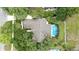Expansive property featuring a screen-enclosed pool surrounded by lush, mature trees, offering both privacy and a tropical feel at 518 Stephanie Ct, Lake Mary, FL 32746