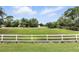 Spacious and lush backyard, perfect for outdoor activities with a white fence and a vast, grassy field beyond at 518 Stephanie Ct, Lake Mary, FL 32746