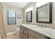 Bright bathroom featuring a double sink vanity with granite countertops and framed mirrors at 518 Stephanie Ct, Lake Mary, FL 32746