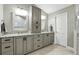 Bathroom featuring dual sinks, granite countertops, and gray shaker cabinets at 518 Stephanie Ct, Lake Mary, FL 32746