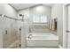 Bright bathroom with a glass-enclosed shower and soaking tub at 518 Stephanie Ct, Lake Mary, FL 32746
