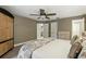 Large bedroom with neutral carpet, ceiling fan, and views of the en suite bathroom at 518 Stephanie Ct, Lake Mary, FL 32746