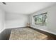 Neutral bedroom featuring dark wood floors, a rug, and large window at 518 Stephanie Ct, Lake Mary, FL 32746