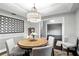 Charming dining room with round table, four chairs, stylish light fixture, and adjacent living space at 518 Stephanie Ct, Lake Mary, FL 32746