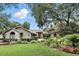 Charming single-story home with brick accents, mature trees and lush landscaping at 518 Stephanie Ct, Lake Mary, FL 32746