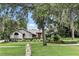Charming single-story home with brick accents, mature trees and lush landscaping at 518 Stephanie Ct, Lake Mary, FL 32746