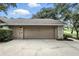 Attached two car garage with a neutral door and brick accents for a classic curb appeal at 518 Stephanie Ct, Lake Mary, FL 32746