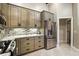 Updated kitchen featuring stainless steel refrigerator and gray cabinets with dark hardware at 518 Stephanie Ct, Lake Mary, FL 32746