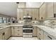 Updated kitchen featuring stainless steel appliances, granite countertops, and mosaic backsplash at 518 Stephanie Ct, Lake Mary, FL 32746