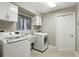 Well-equipped laundry room with modern washer and dryer and ample storage at 518 Stephanie Ct, Lake Mary, FL 32746