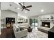 Open-concept living room with a fireplace, hardwood floors, backyard views and an adjacent kitchen at 518 Stephanie Ct, Lake Mary, FL 32746