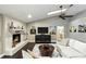 Cozy living room featuring a fireplace, hardwood floors, skylight and television at 518 Stephanie Ct, Lake Mary, FL 32746