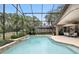 Beautiful screened-in pool surrounded by mature trees, green lawns, and a patio area at 518 Stephanie Ct, Lake Mary, FL 32746