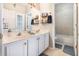 Well-lit bathroom featuring double sinks, a vanity, and a shower-tub combo for a functional and inviting space at 538 Majestic Oak Dr, Apopka, FL 32712