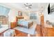 Airy main bedroom featuring wood furniture, a ceiling fan, and a serene, light-filled atmosphere at 538 Majestic Oak Dr, Apopka, FL 32712