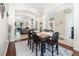 Elegant dining area with stylish lighting, a rustic wood table, and an open layout to the living spaces at 538 Majestic Oak Dr, Apopka, FL 32712