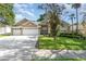 Charming home featuring a well-manicured lawn, mature landscaping, and a spacious three-car garage at 538 Majestic Oak Dr, Apopka, FL 32712