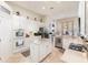 Bright kitchen featuring white cabinetry, modern appliances, and a center island with ample counter space at 538 Majestic Oak Dr, Apopka, FL 32712