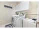 Well-equipped laundry room with modern washer, dryer, and sink at 538 Majestic Oak Dr, Apopka, FL 32712