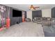 Media room with large television, comfortable seating and a ceiling fan at 538 Majestic Oak Dr, Apopka, FL 32712