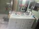 Bathroom with double vanity, marble countertop, and decorative mirrors at 679 Midori St, Orlando, FL 32811