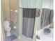 Bathroom with toilet and shower featuring gray curtain at 679 Midori St, Orlando, FL 32811