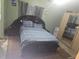 Bedroom with a dark wood bed frame and patterned rug at 679 Midori St, Orlando, FL 32811