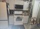 Modern kitchen with white appliances, granite countertops, and ample storage at 679 Midori St, Orlando, FL 32811